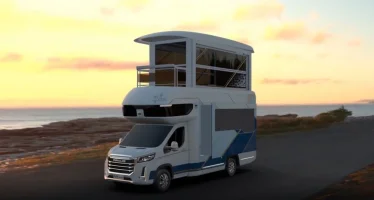 this-tiny-rv-has-a-pop-up-upper-level-with-balcony-and-its-own-elevator_1.webp