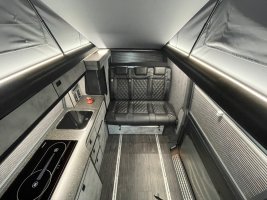 bespoke kitchen in grey and quarts with lesther seat full campervan conversion.jpg