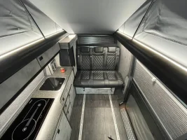 bespoke kitchen in grey and quarts with lesther seat full campervan conversion.webp